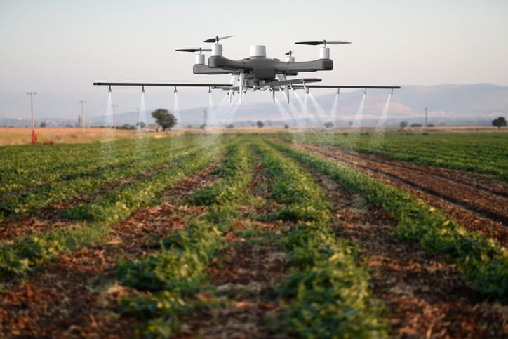 Drone spraying a field