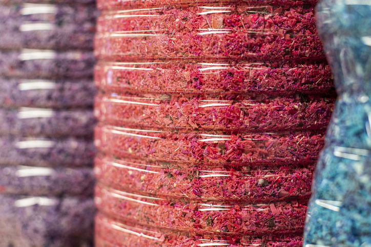 Close-up of containers full of crushed used plastic