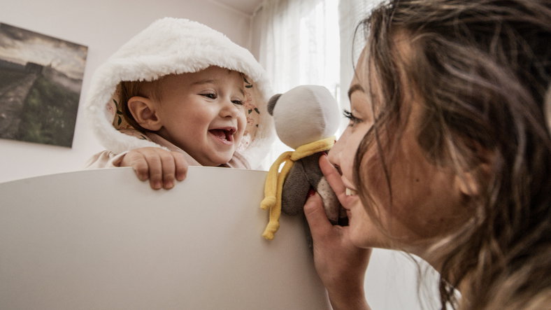 Mum playing with baby at home