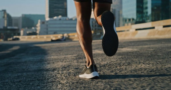 Closeup shot of a man running outdoors in an urban landscape