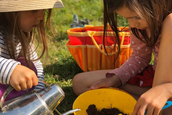 Two young girls playing in nature