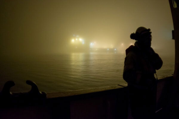 North Sea oil rig worker at sea on a foggy dark night