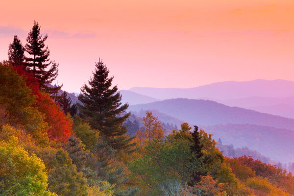 Sunrise over mountains and forests in autumn