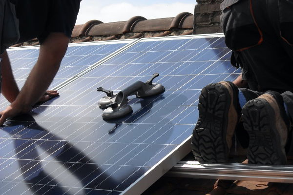 Solar panels being installed on a roof
