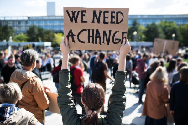 A rear view of people with placards and posters on global strike for climate change