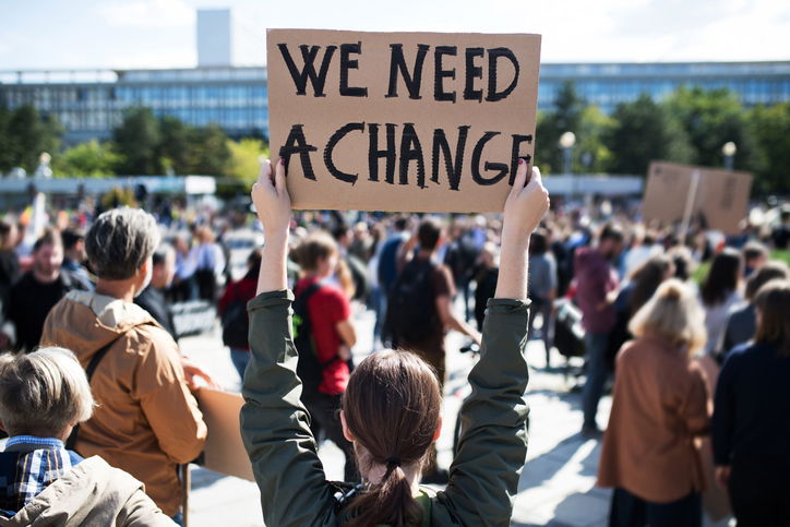 A rear view of people with placards and posters on global strike for climate change