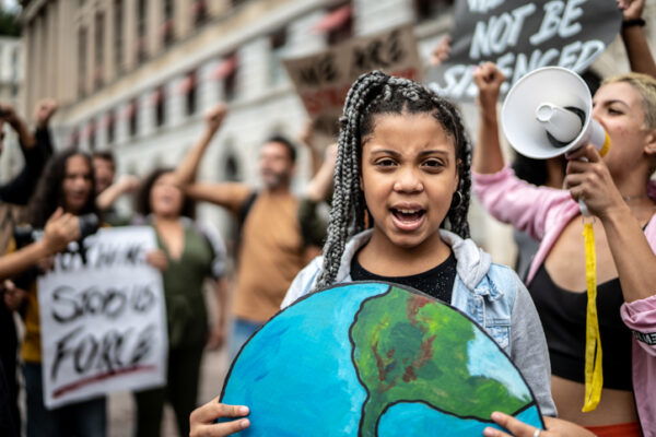 Teenage girl holding signs during on a demonstration for environmentalism