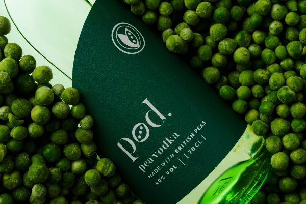 A bottle of Pod Pea Vodka on a bed of peas