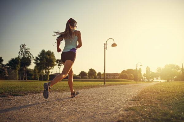 Teenage girl jogging in city park